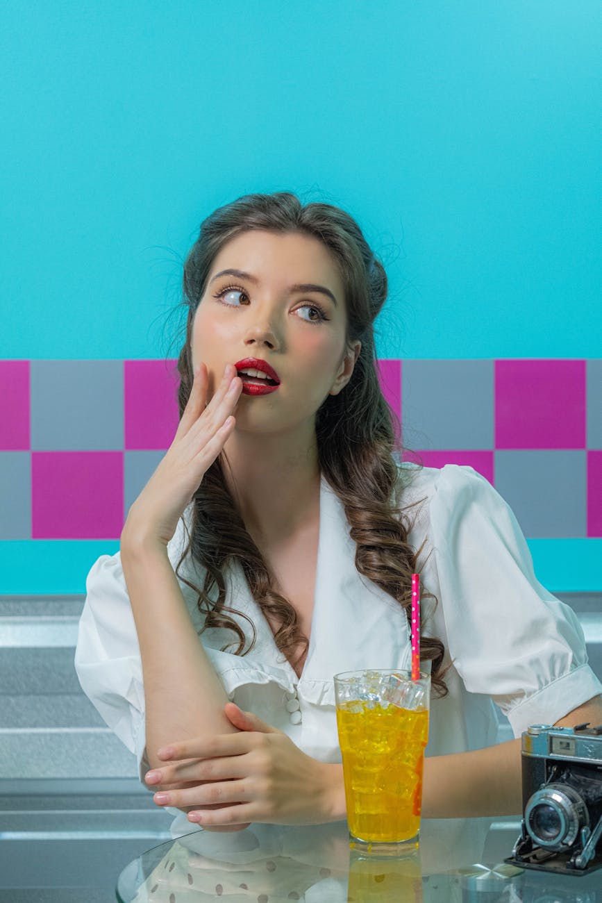 a woman sitting with a drink